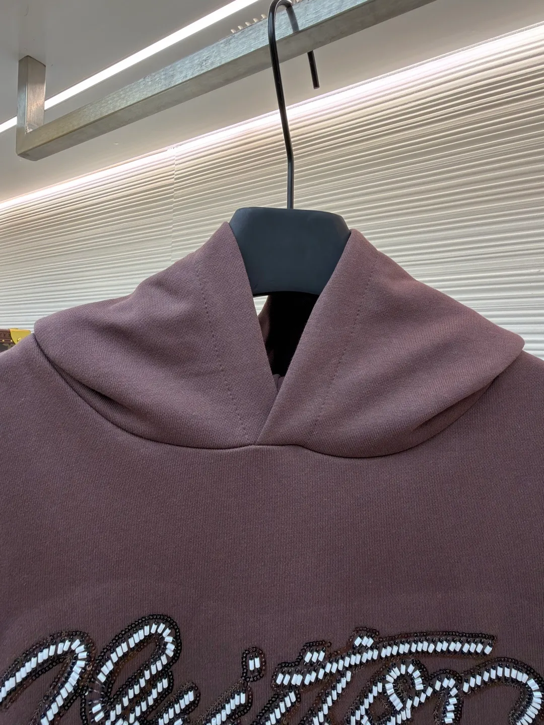 LOUIS VUITTON beaded embroidered letter hooded sweatshirt ●Item number: 1682118-A60 ●Material: pure cotton fish scale base fabric ●Technology: Pearl embroidery production ●Color: brown ●Version: fitted version ●Weight: about 830 grams ●Size: S-M-L-XL ●Description: The fabric is made of 26S double yarn + 10S fish scale bottom brushed fabric, weight 380g, with 21S double yarn 2*2 rib, weight 380g. This kind of fabric is treated with fleece to form a layer of soft and plump fluff on the inside; the improved fish scale knitting method forms a delicate concave and convex texture on the bottom surface, similar to the arrangement of fish scales. Effectively increases the air storage layer and improves thermal insulation performance. The front of the fabric is smooth and smooth, while the back is soft and waxy. It has excellent moisture absorption, breathability, wrinkle resistance and drape, and is thicker and crisper than ordinary sweatshirt materials. It gives clothes excellent warmth retention, breathability and skin-friendly touch. The Vuitton script on the chest is embroidered with beads. During the embroidery process, tiny beads are fixed on the fabric together with embroidery thread. The direct characteristics brought by this process are a strong three-dimensional sense, a unique sense of weight and a reflective effect that changes with the light. The overall wiring is straight and delicate, the fabric is comfortable and soft, and the color is consistent without color difference. It can be matched with the same style to create a fashionable look and control various occasions. Customized accessories, complete with three standards, same style for men and women!